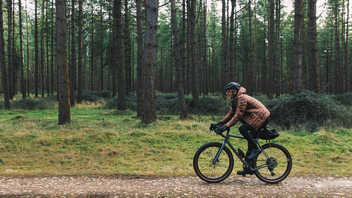 a person riding bike in the woods