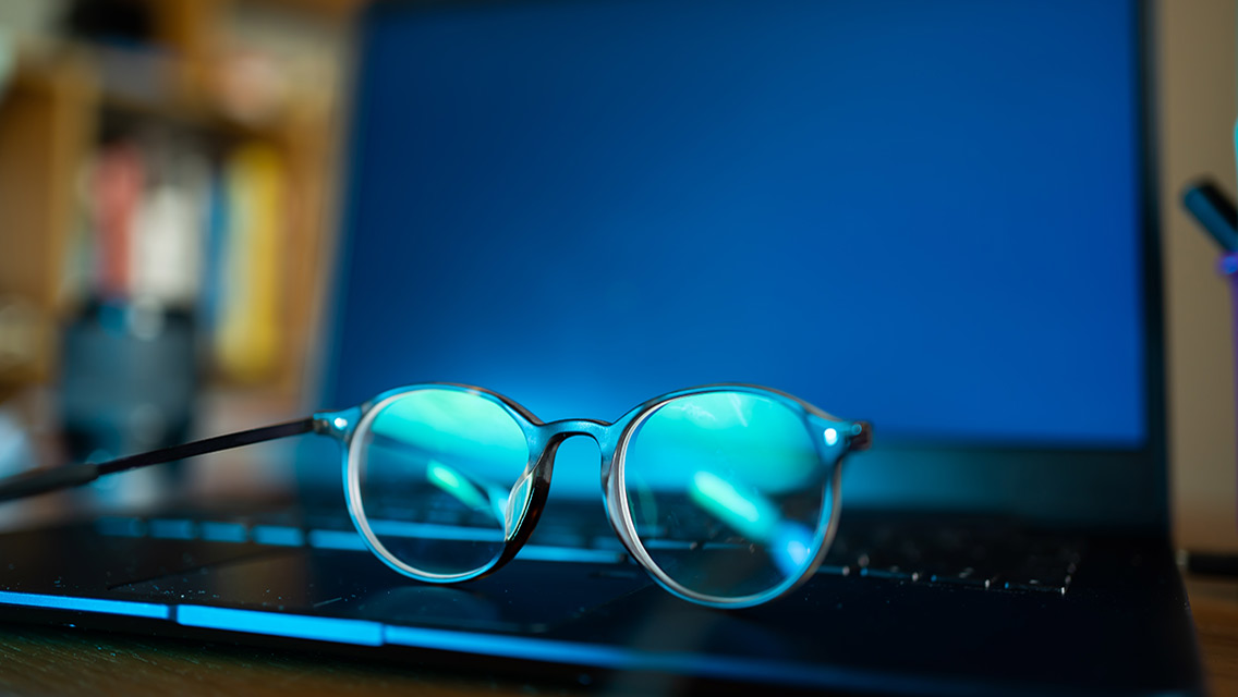 a pair of glasses sits on a compute