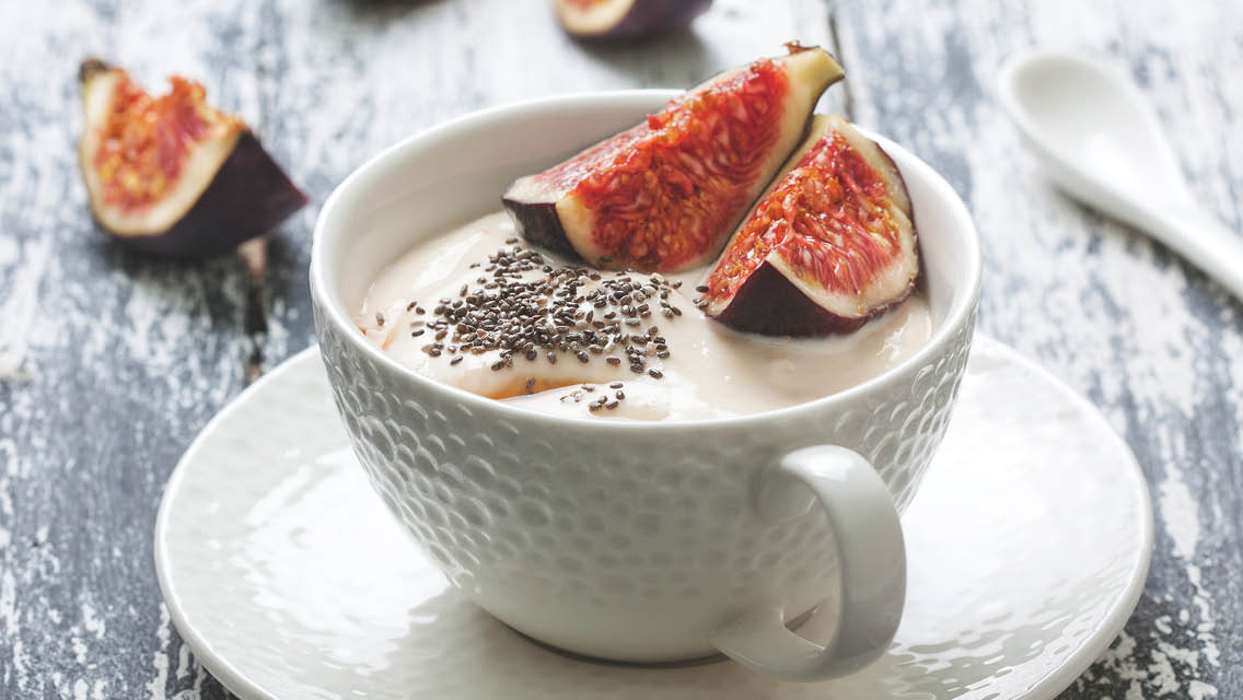 a bowl with yogurt topped with fig