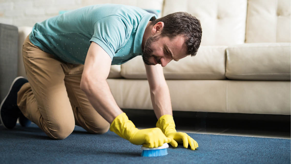 a man cleans his carpet