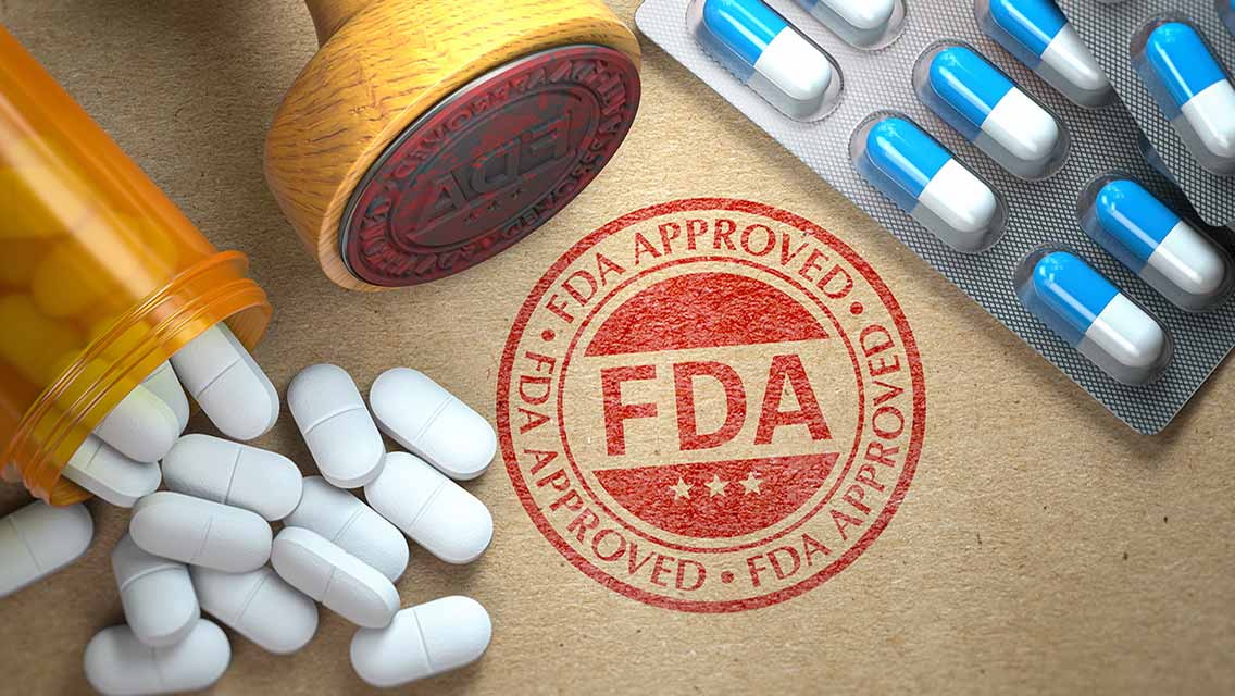 an FDA stamp of approval surrounded by pills