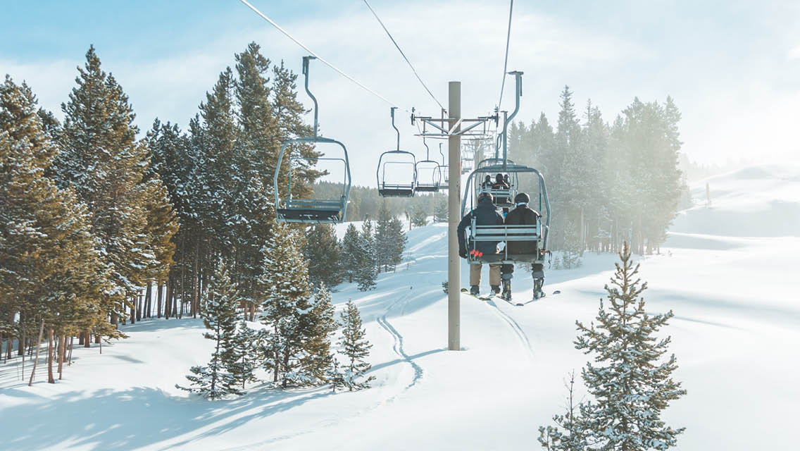 people riding a chair lift