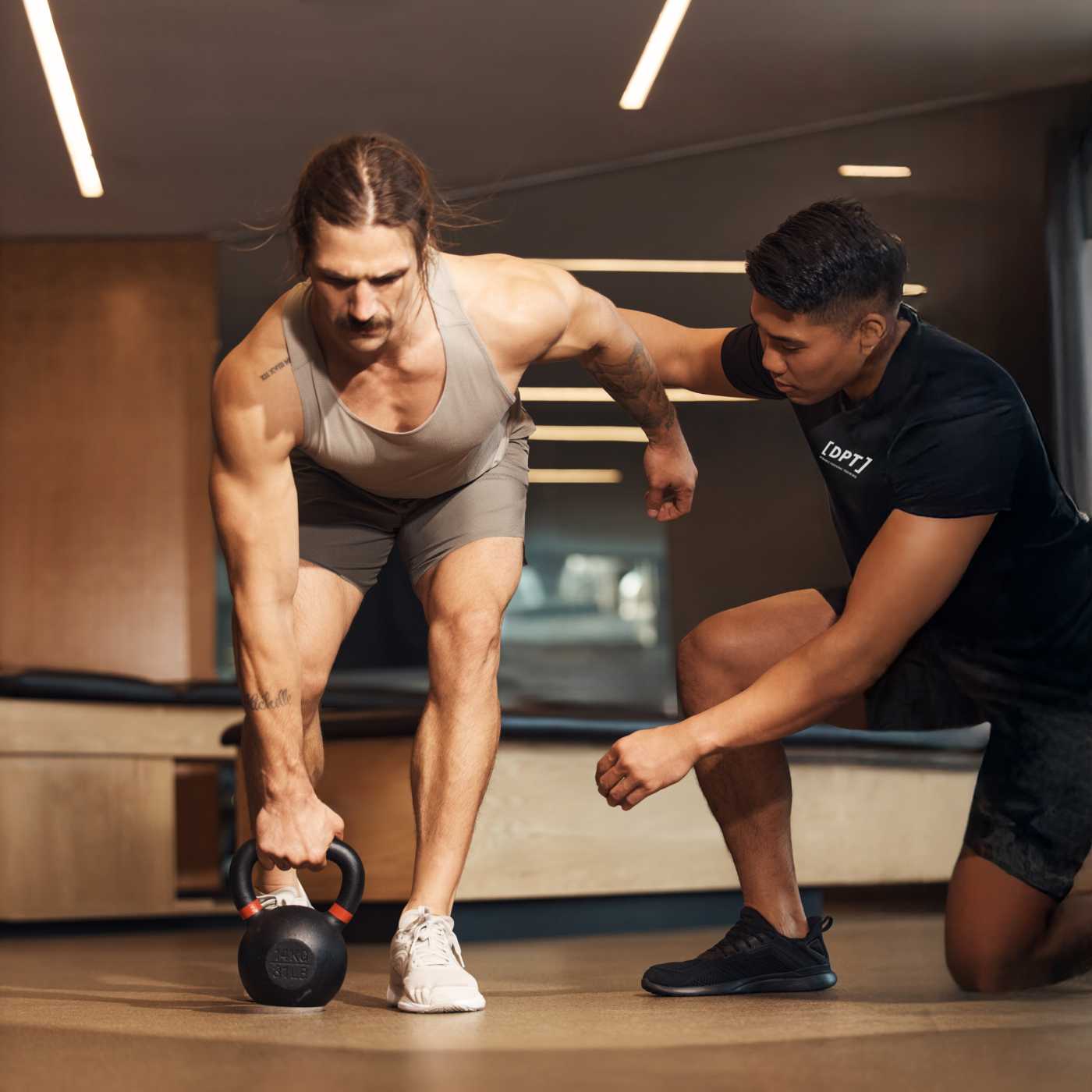 member working with dynamic personal trainer