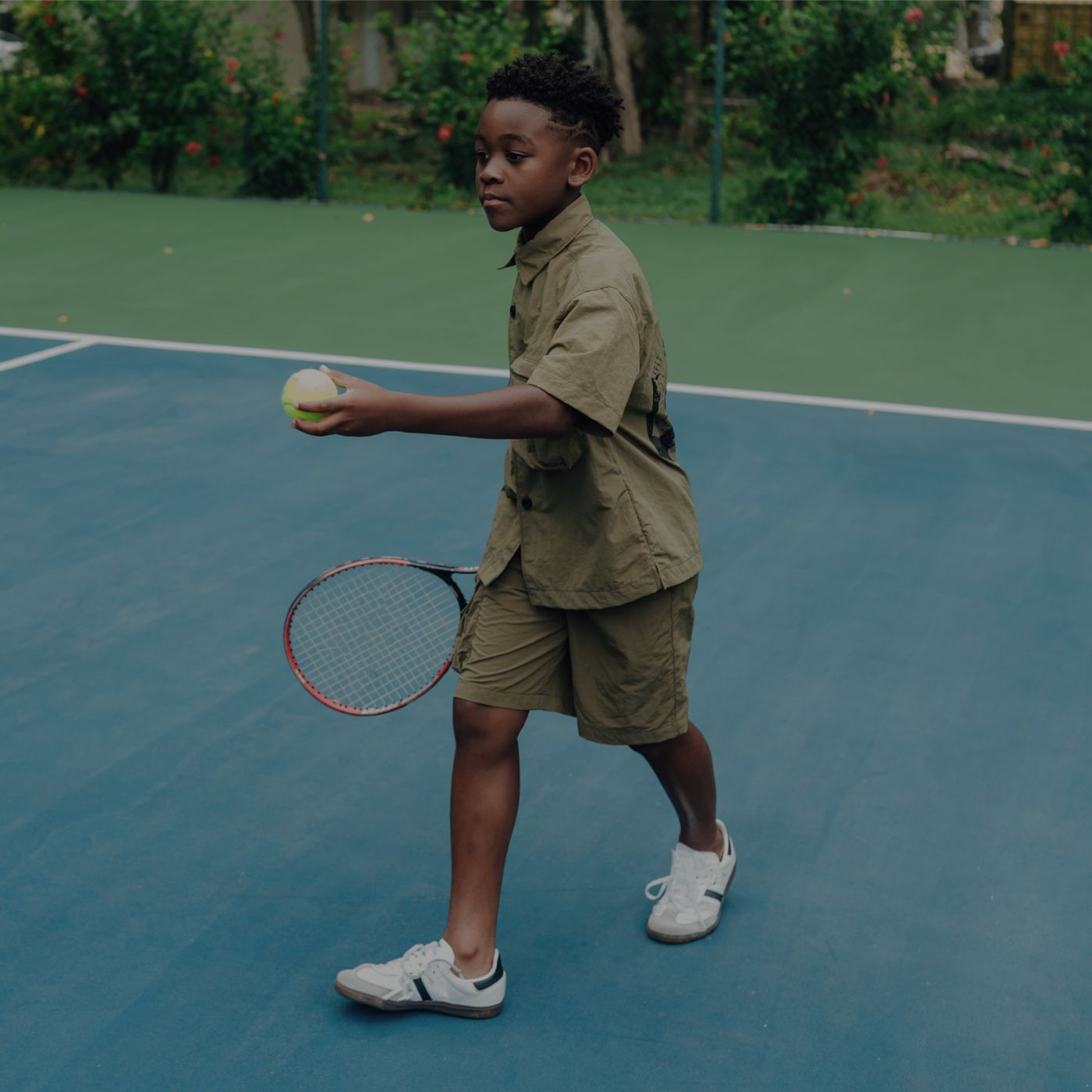 kid with tennis racket and ball