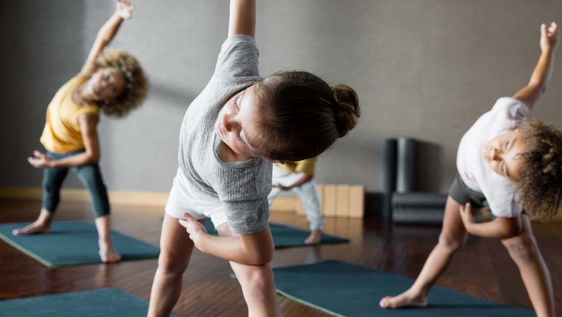 Kids participating in a yoga class at Life Time.