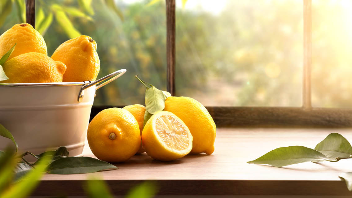lemons is on a counter with a with a window overlooking a lemon farm