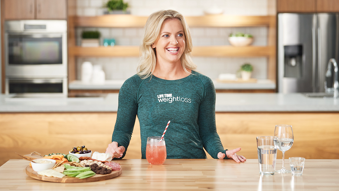 Coach Anika inside of a kitchen.