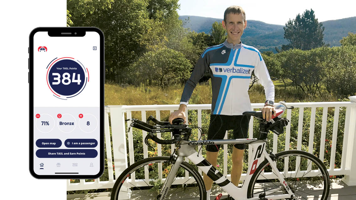 Ryan Frankel with his bike an a photo of his app