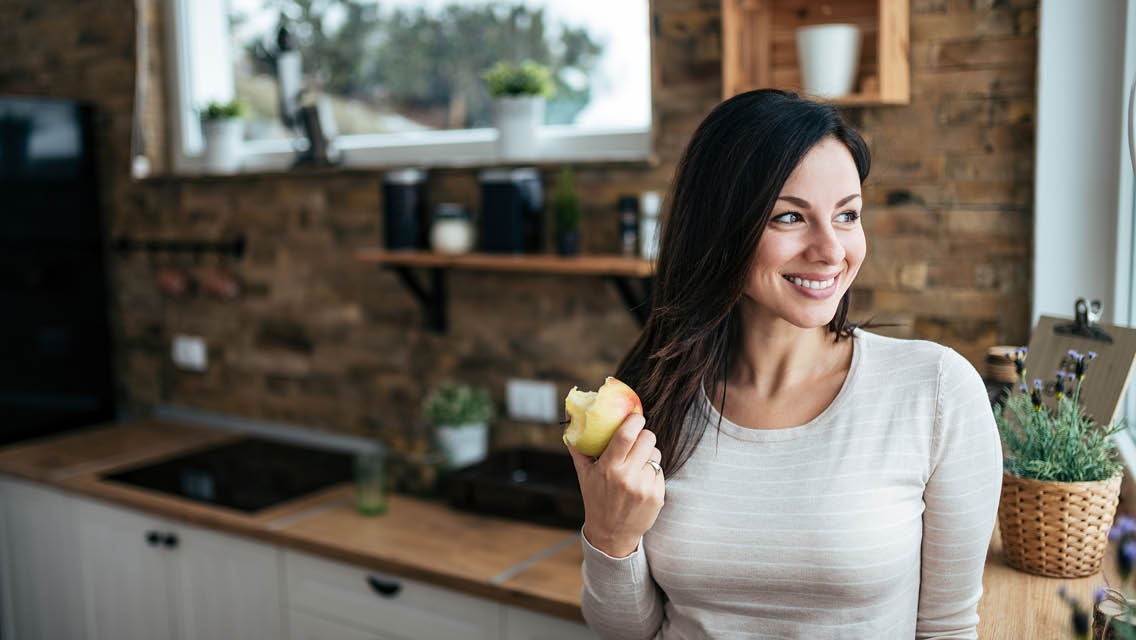 a woman eats an apple
