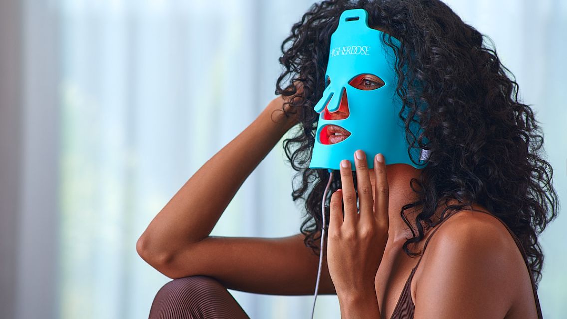 woman wearing higher DOSE red light face mask