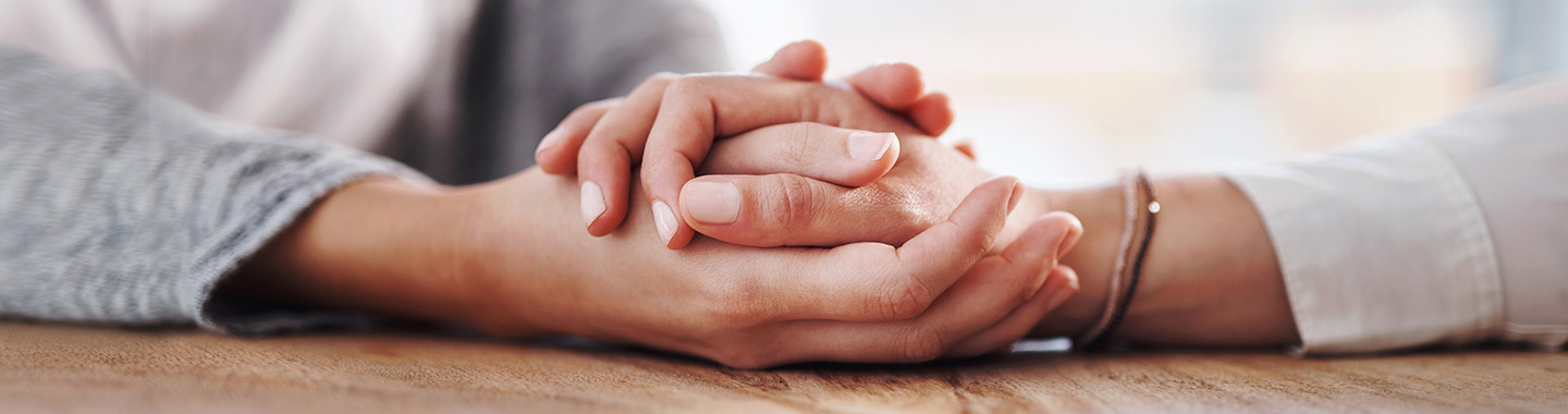 a person holds another person's hand