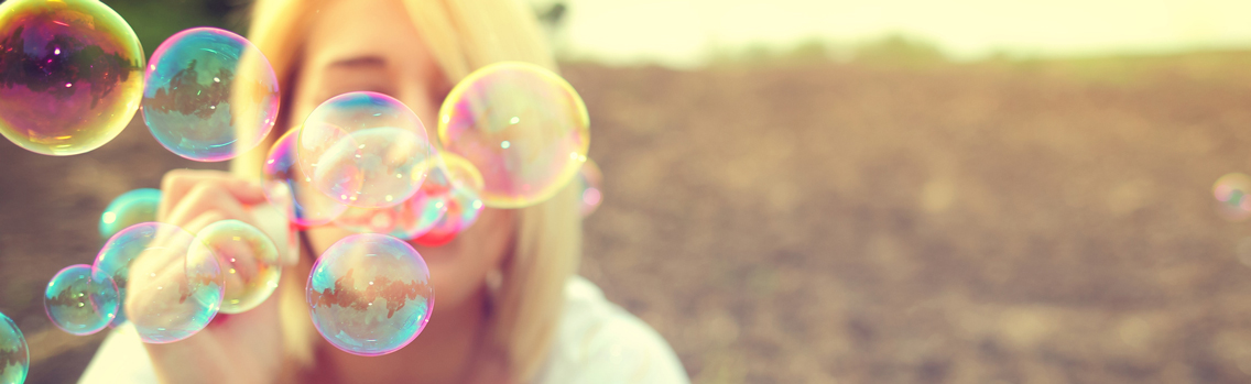 a woman blows bubbles