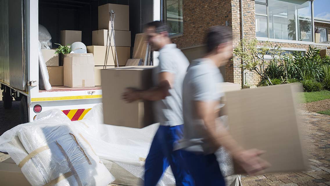 people moving boxes to a moving truck