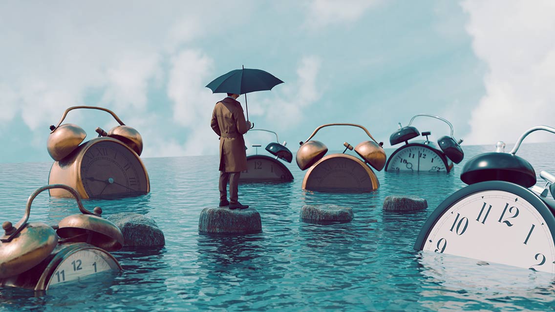 photo illustration of a person balanced on a rock surrounded by water and submerged clocks
