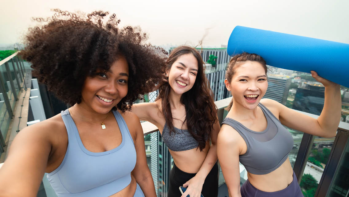 teen girls wearing athletic apparel smile and prepare to workout