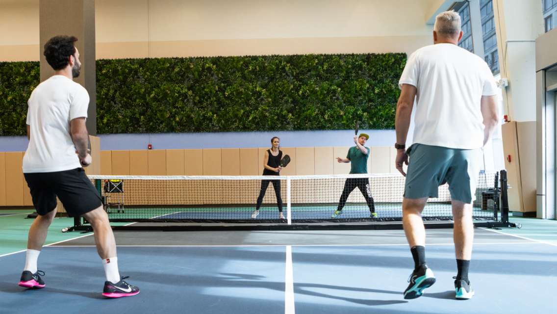 people playing pickleball on an indoor court