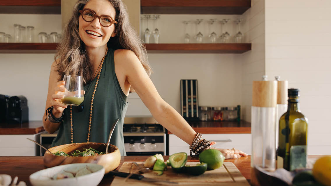 a woman eating health food in a kitchen