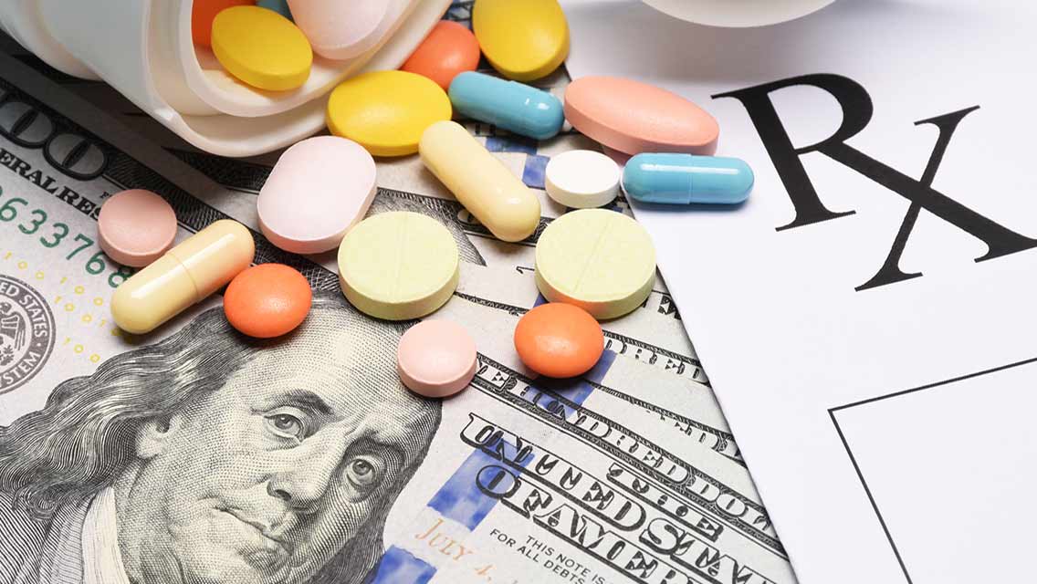 a $20 bill, Rx form and variety of pills