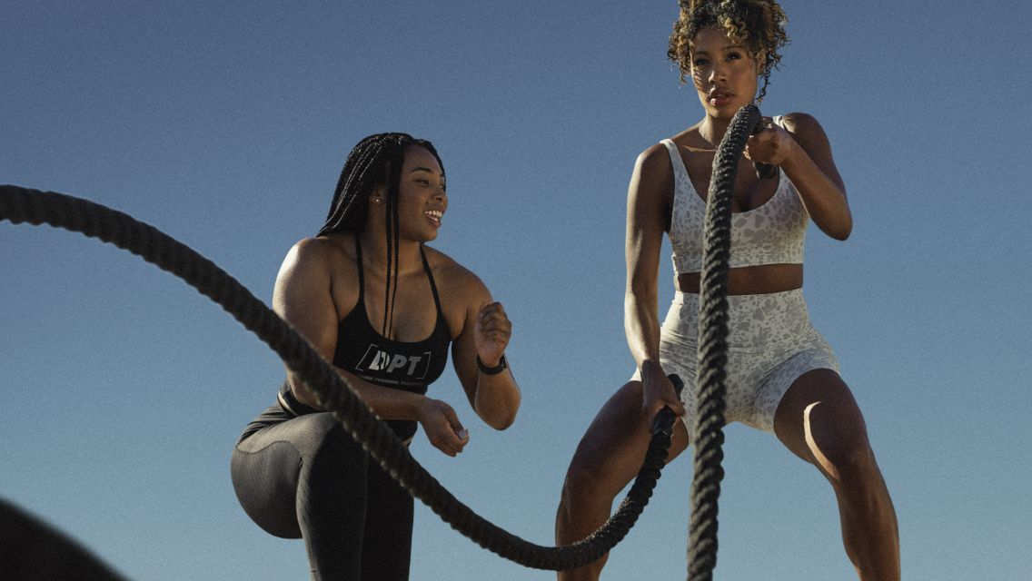Two people exercising with ropes