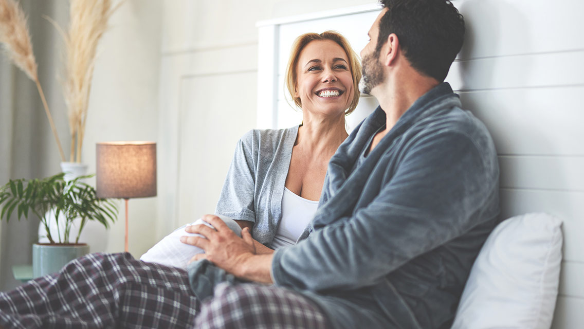 A couple talking in bed at home