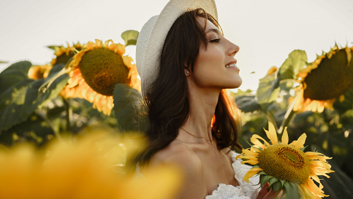 a woman in a field of sunflowers