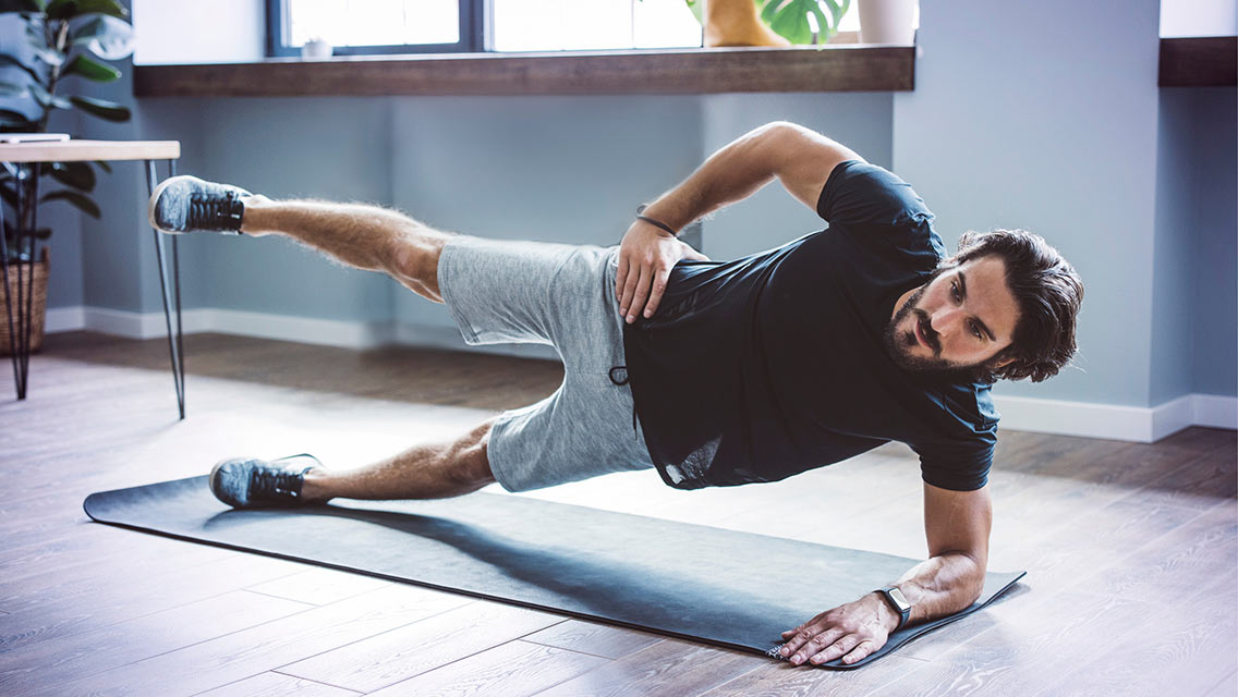 a man holds side plank