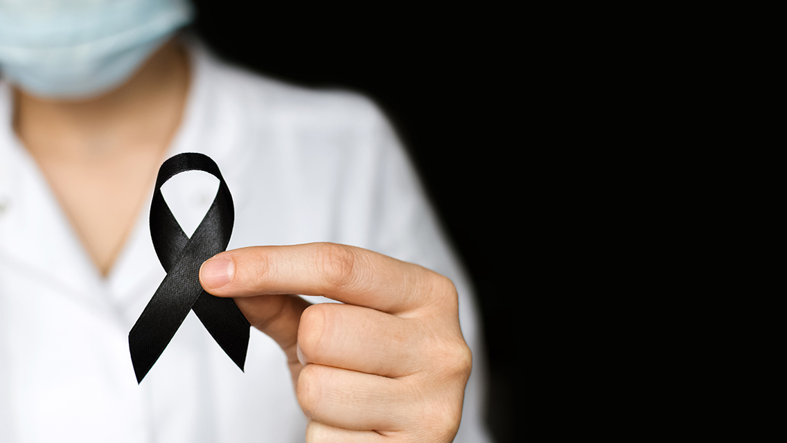 a person holds a black ribbon