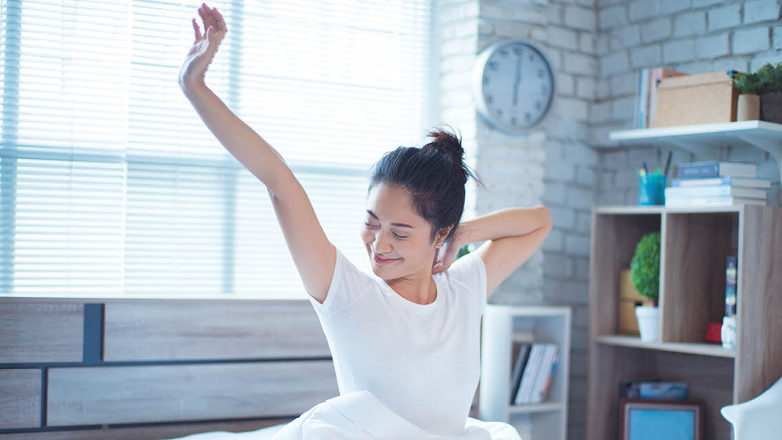 a woman wakes and stretches