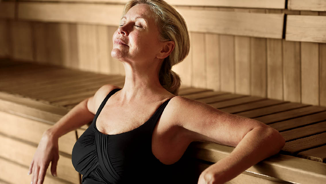 a woman relaxes in a sauna