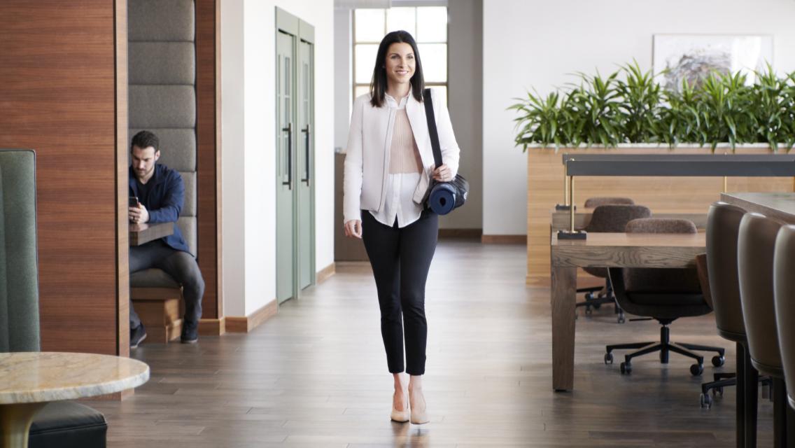 woman walking into life time work office