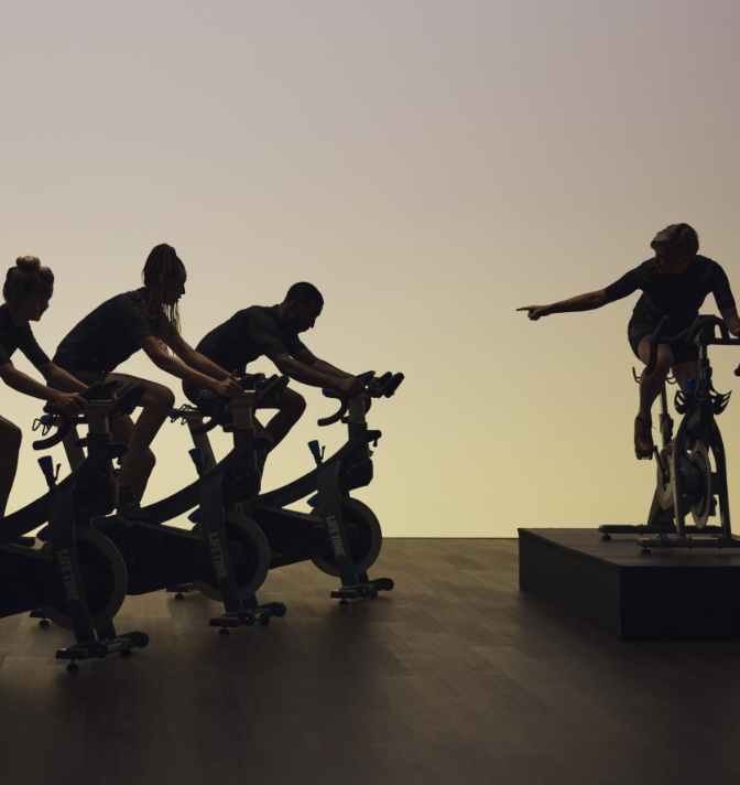 Individuals in a cycle fitness class.
