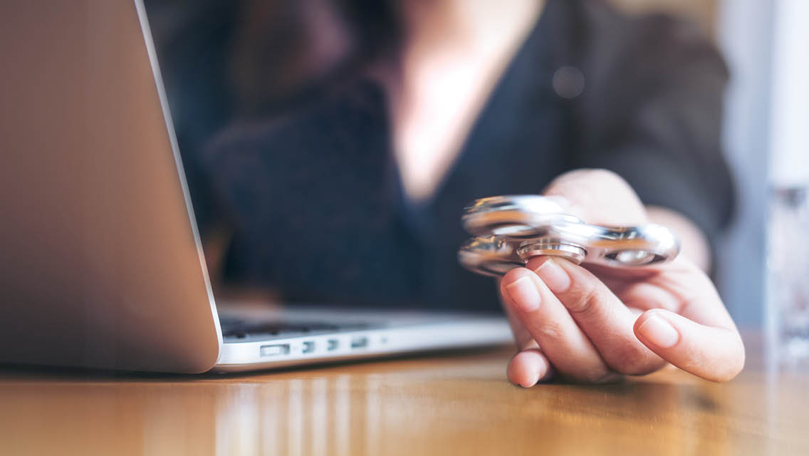 a person at work with a fidget spinner