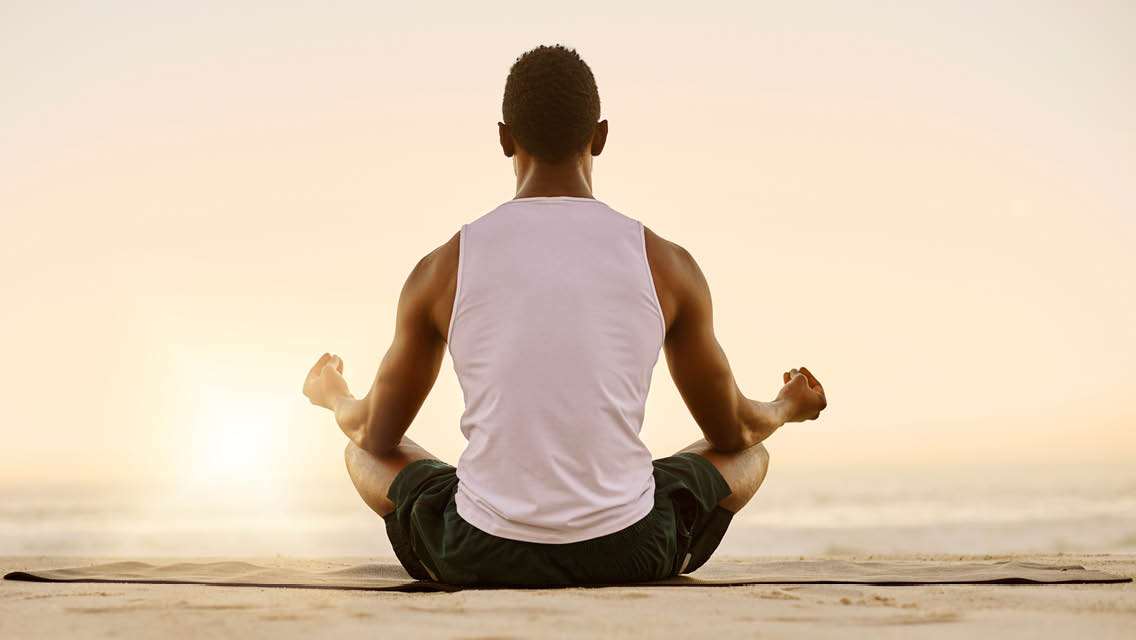 a man sits in a meditation pose