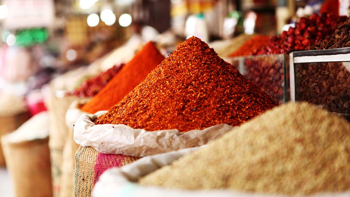 a basket of spices at an open air market