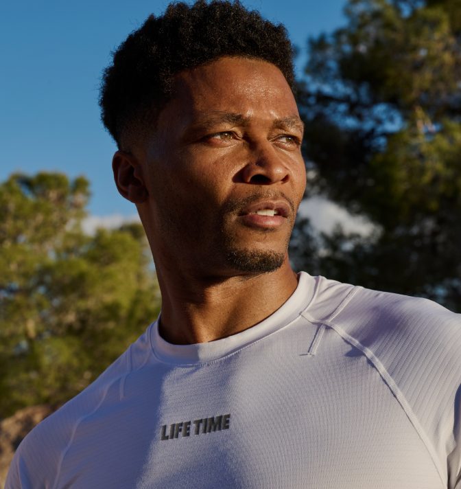 A man outside wearing a Life Time apparel shirt.