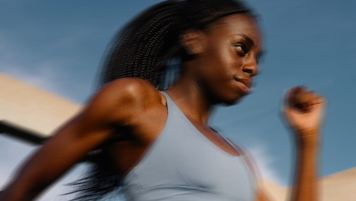 Woman in motion running in workout gear.