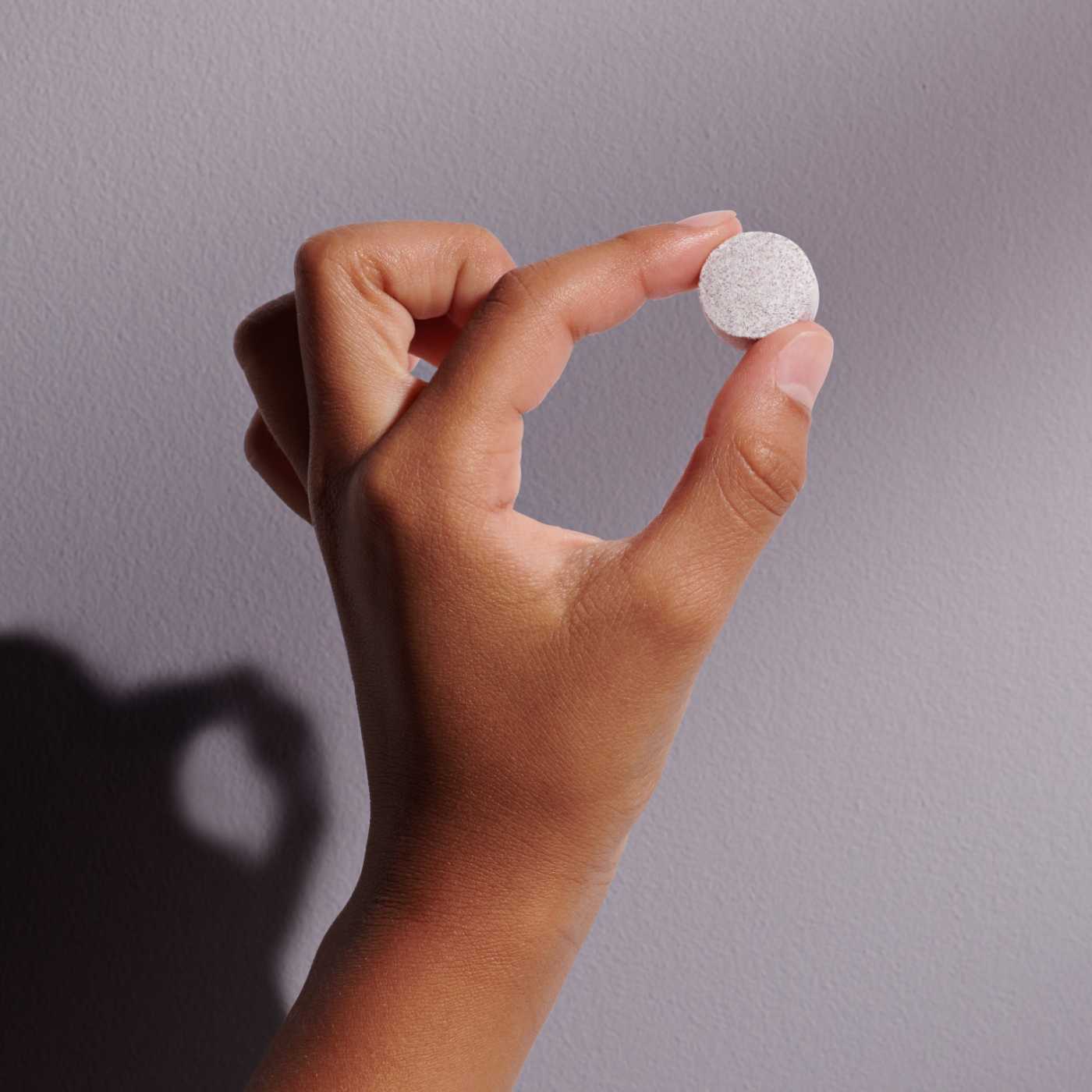 hand holding capsule