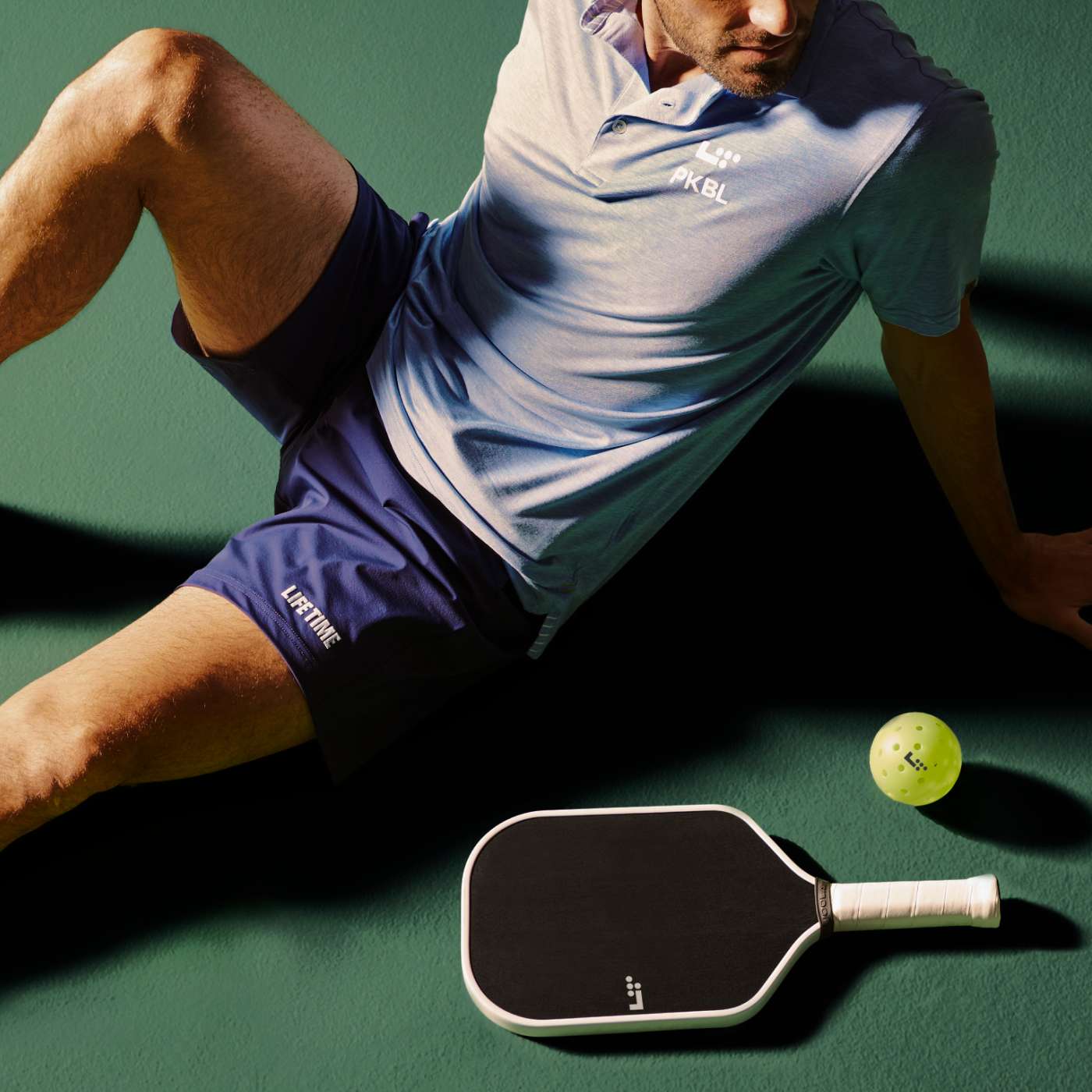 man sitting on pickleball court