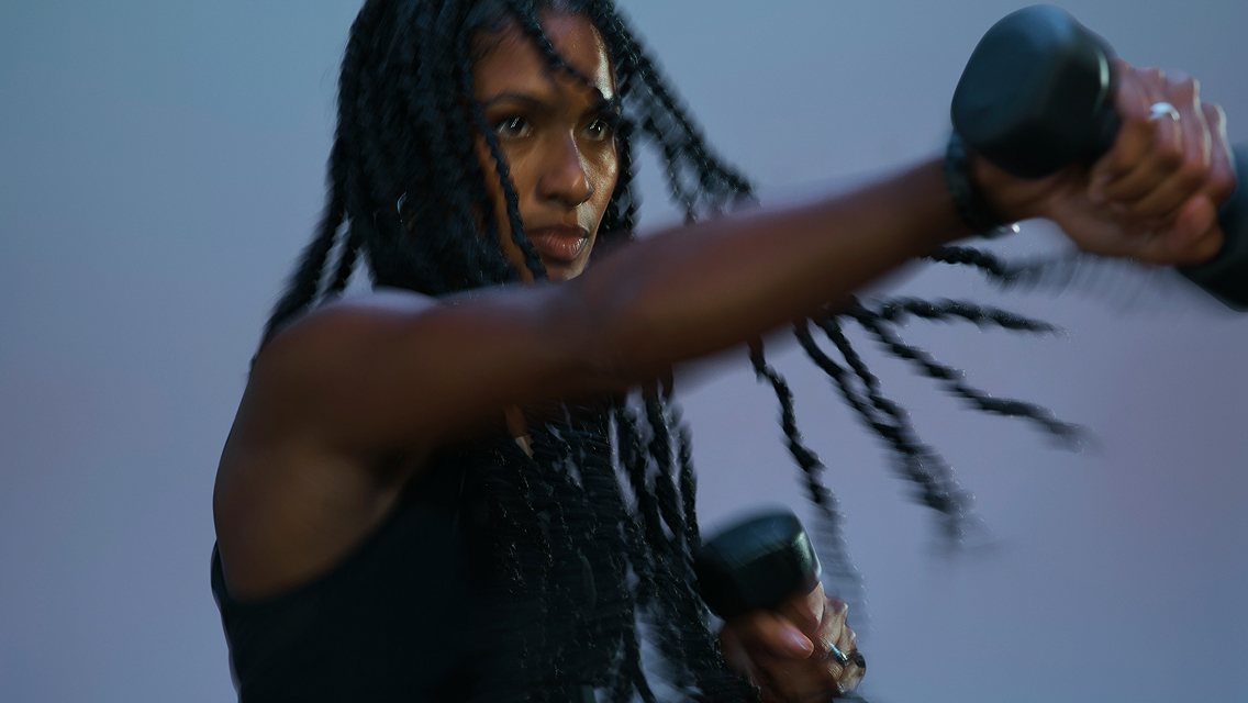 woman holding dumbbell