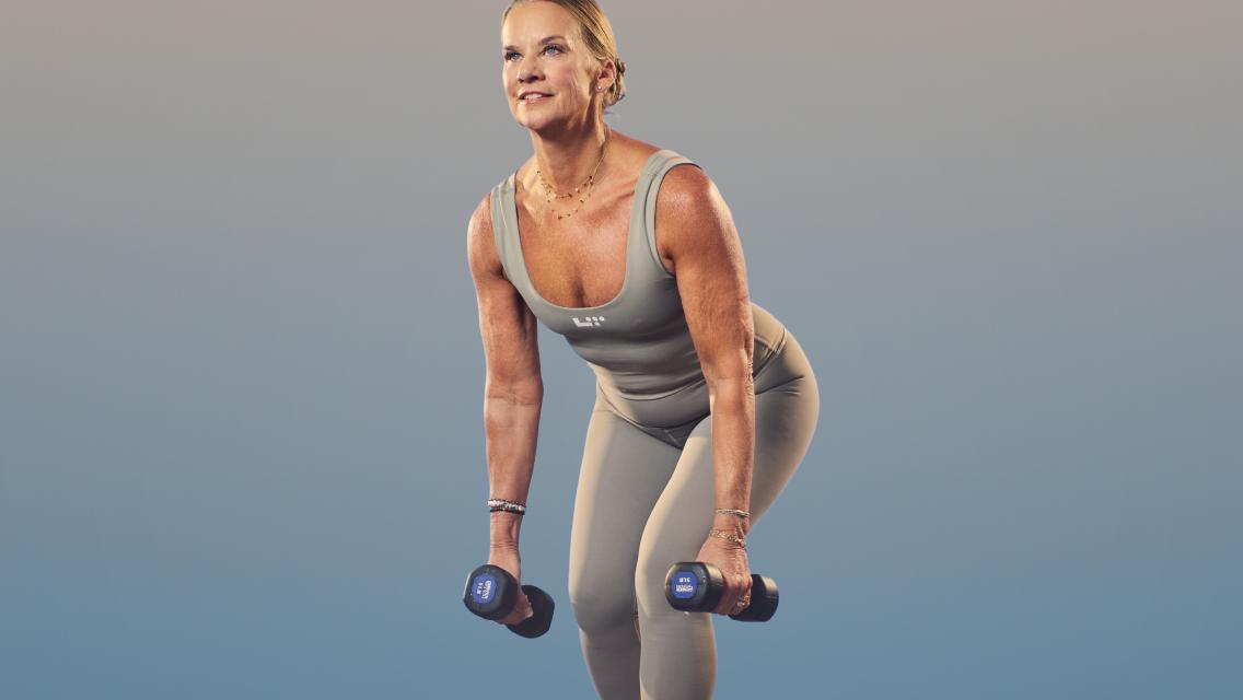 Woman holding two dumbbells in a squat position