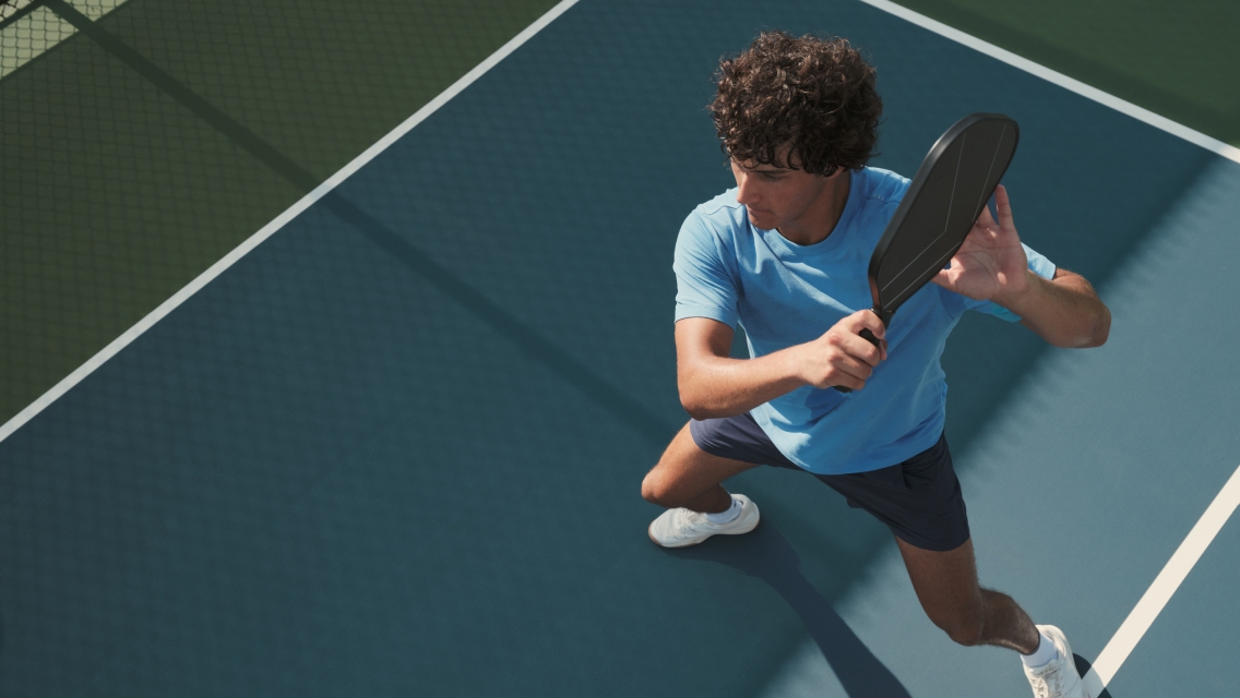 man hitting a pickleball