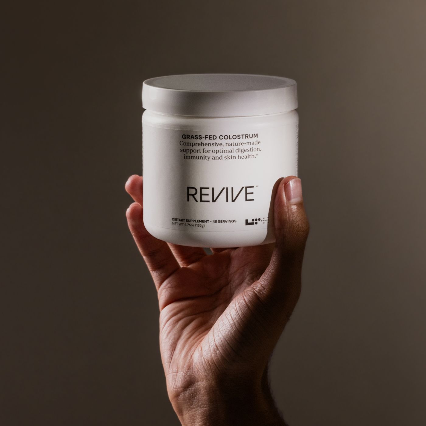 hand holding a tub of LTH revive