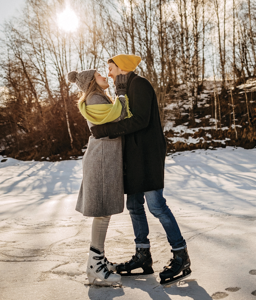 a couple embraces while ice skating