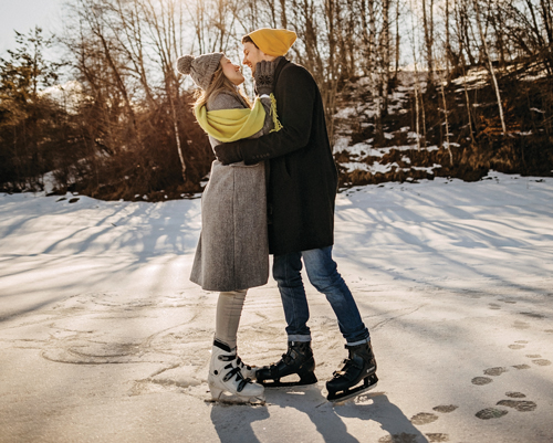 a couple embraces while ice skating