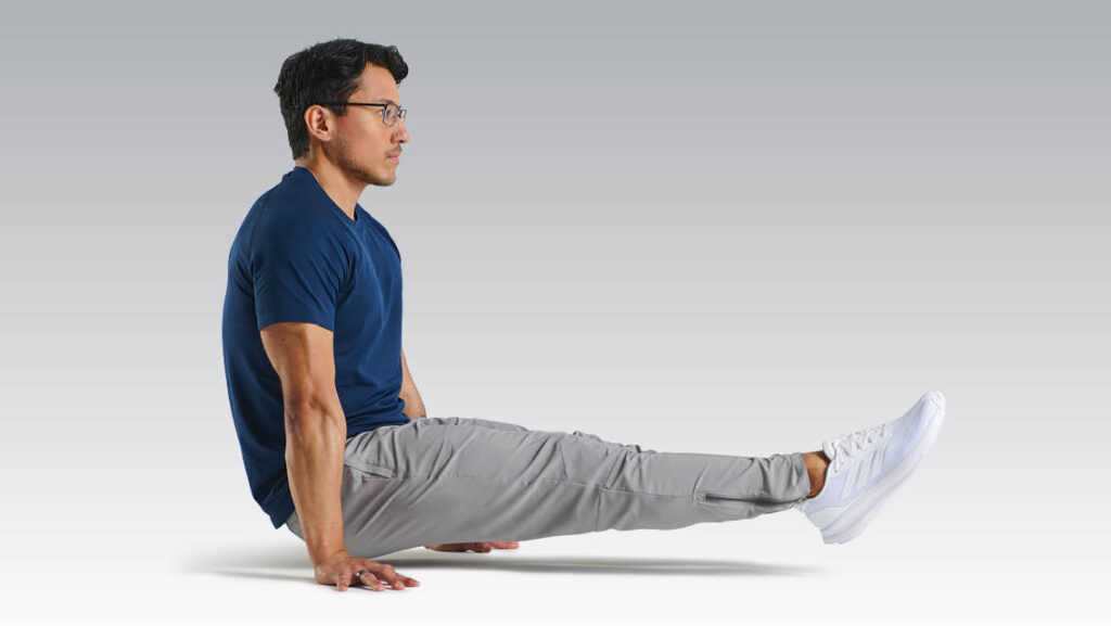 a man performs the L-sit