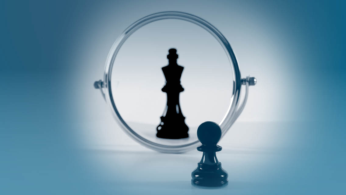 a chess pawns looks through a mirror and sees a king