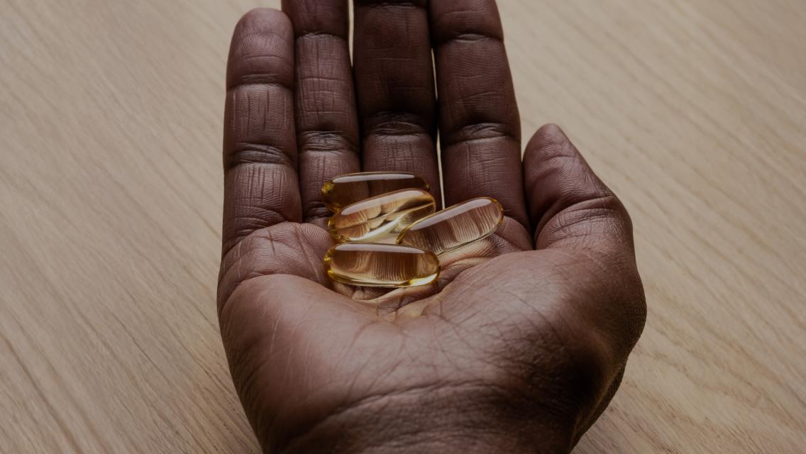 hand holding supplement pills