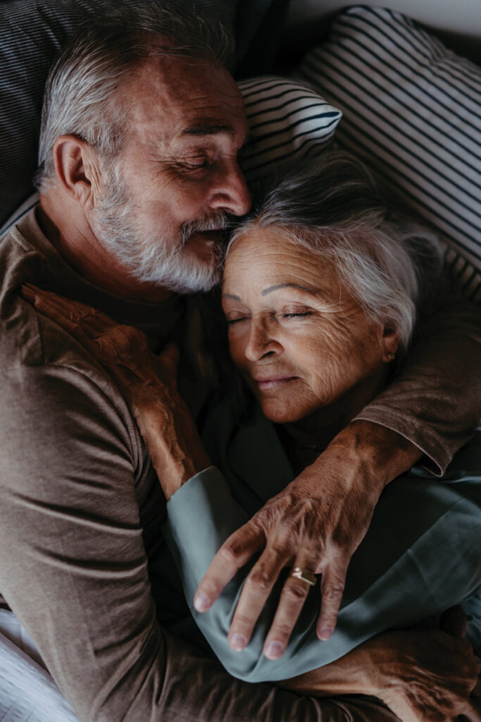 a senior couple snuggles