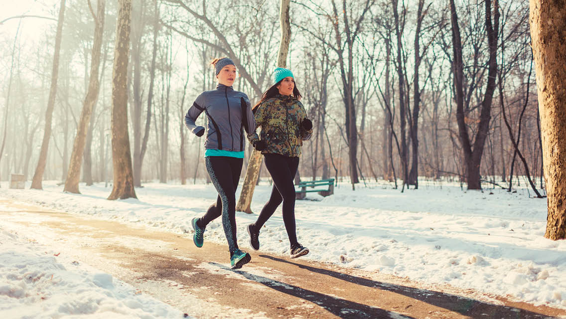 two people run during the winter