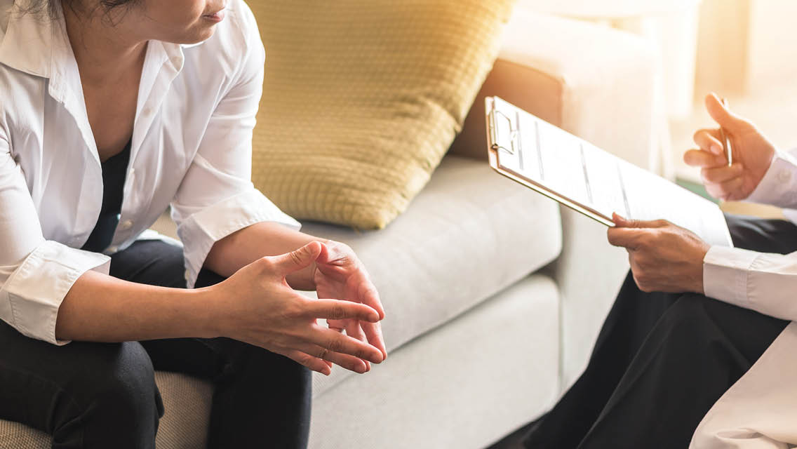 a woman being interviewed by a menopause support specialist